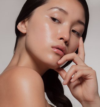 young asian woman with glowing skin