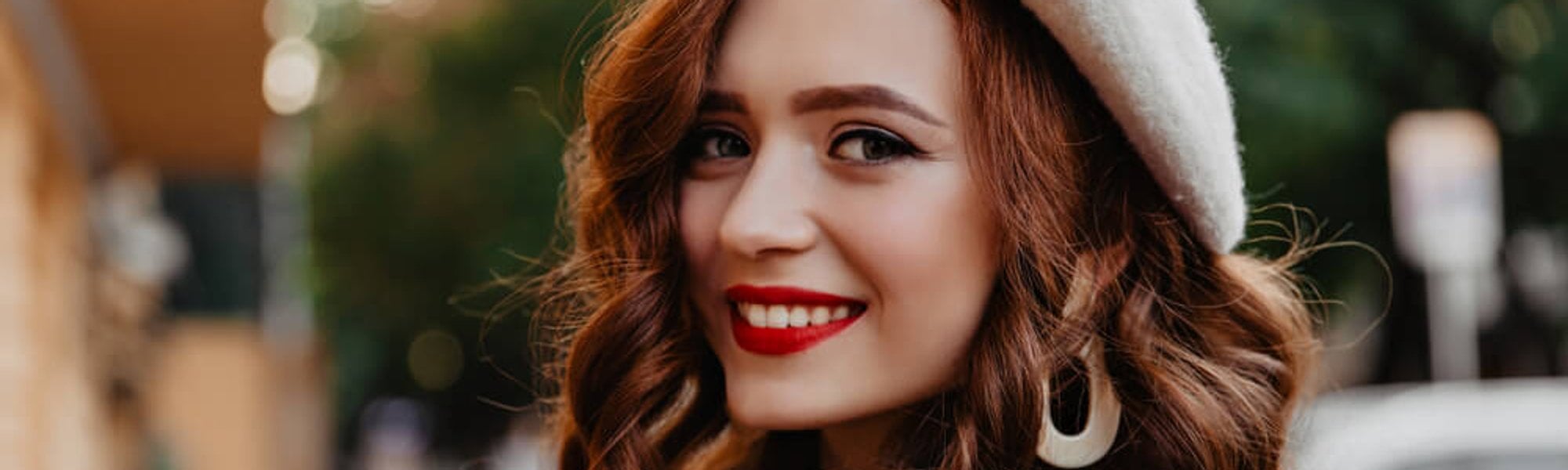 Beautiful happy woman wearing a French beret and red lipstick