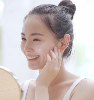Asian woman doing her skincare routine